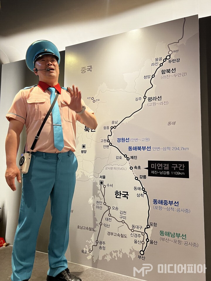 객차에서는 가상의 공간 북한에 도착하기 전, 북측 안내원으로 분장한 배우가 북의 사투리로 평양 시내의 주요한 곳을 설명하고 있는 모습이다. Ⓒ강승혁